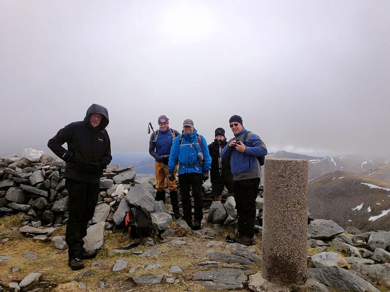team on misty summit of Bein Fhada. Photo by Paul Stock